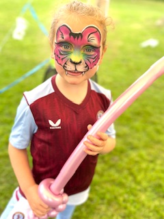 Girl with leopard face paint. holding a balloon sword in Arleston, telford